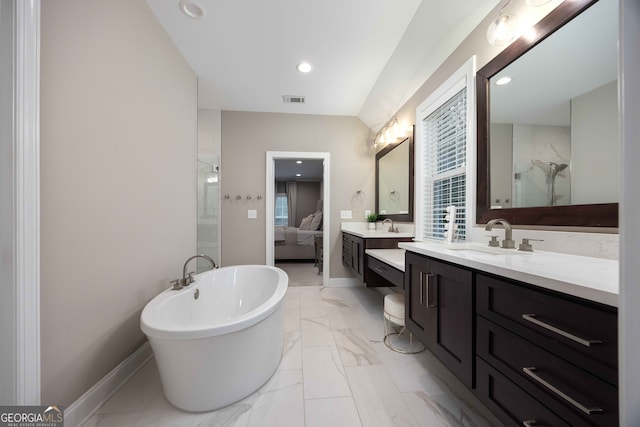 bathroom featuring a washtub and vanity