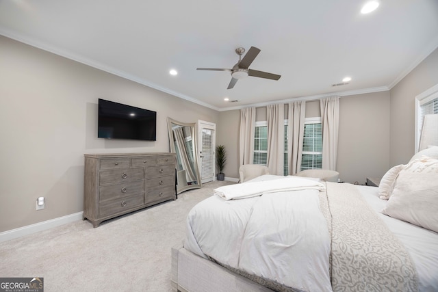 bedroom featuring ornamental molding, light colored carpet, and ceiling fan