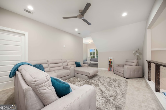 home theater with light carpet, ceiling fan, and vaulted ceiling