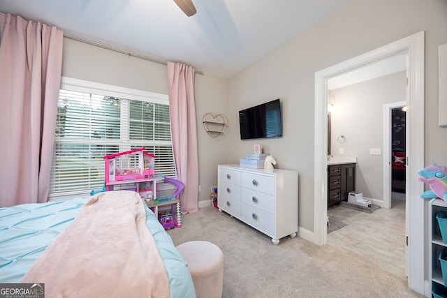 carpeted bedroom featuring ceiling fan and ensuite bath