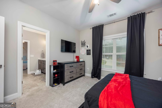 carpeted bedroom featuring ensuite bathroom and ceiling fan