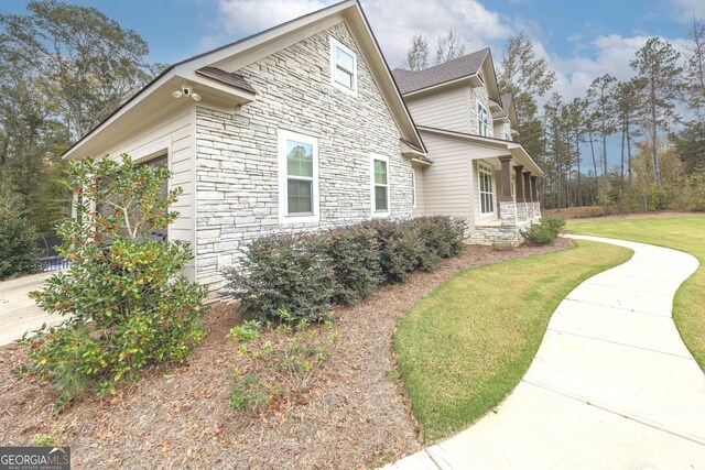 view of property exterior with a garage and a yard