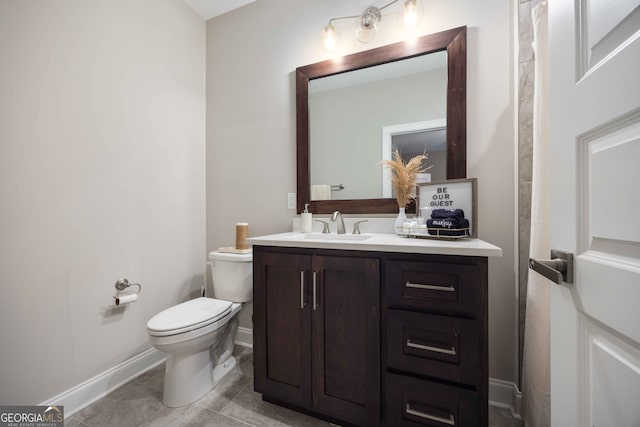 bathroom featuring vanity, tile patterned floors, and toilet