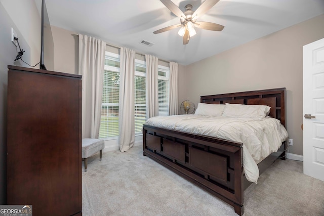 bedroom with ceiling fan and light carpet