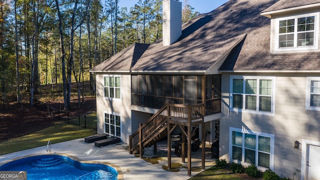 back of house featuring a patio area and a sunroom