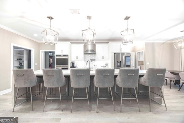 kitchen featuring white cabinets, pendant lighting, and appliances with stainless steel finishes