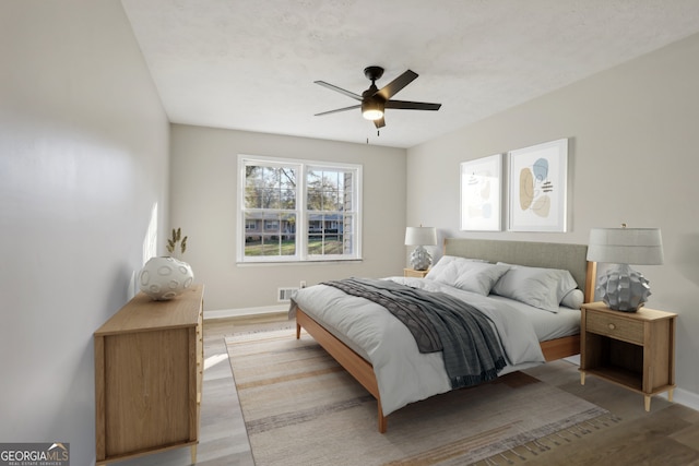 bedroom with ceiling fan and light wood-type flooring