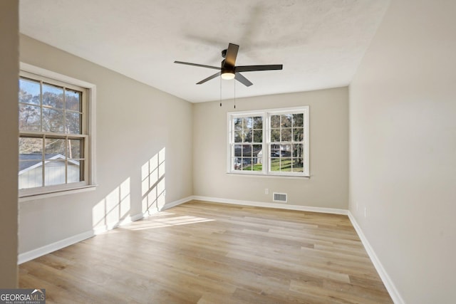 empty room with ceiling fan and light wood-type flooring