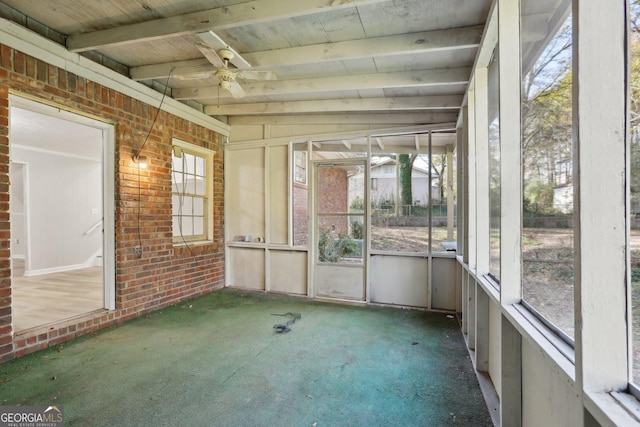 unfurnished sunroom featuring vaulted ceiling with beams and ceiling fan