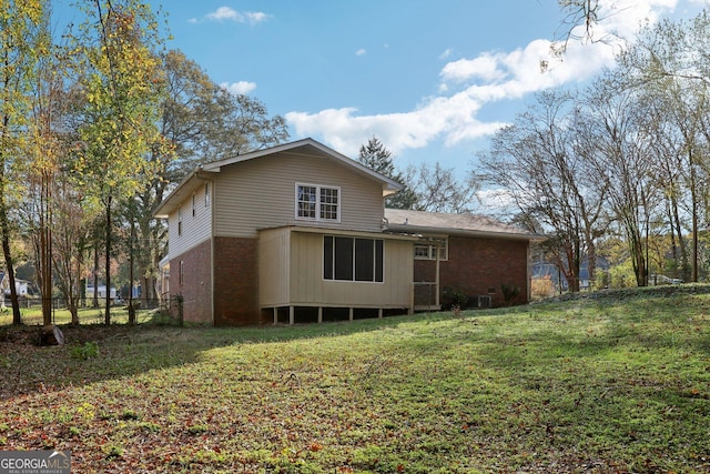 back of property featuring a yard