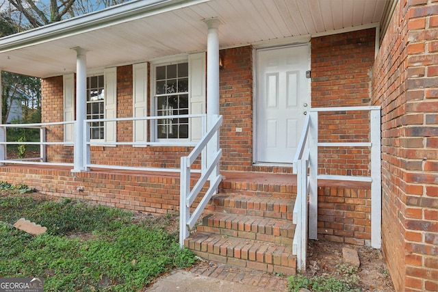 view of exterior entry with a porch