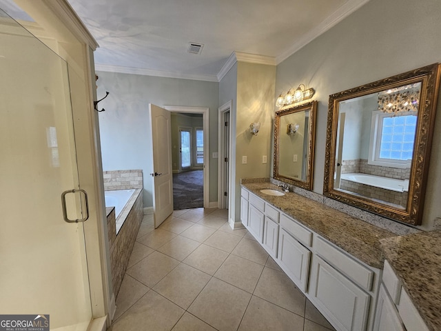 bathroom featuring tile patterned floors, vanity, crown molding, and a relaxing tiled tub