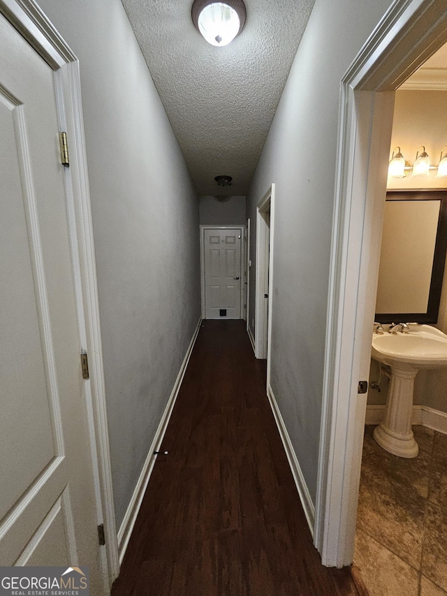 corridor featuring a textured ceiling