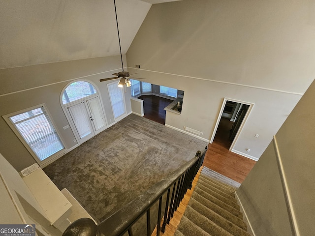 entryway featuring dark hardwood / wood-style floors, ceiling fan, and high vaulted ceiling