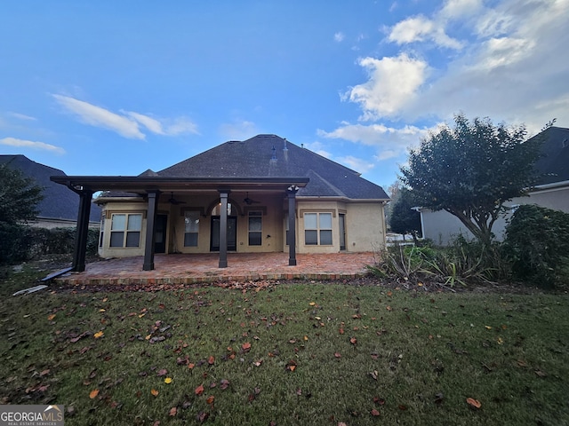 back of property featuring a yard and a patio