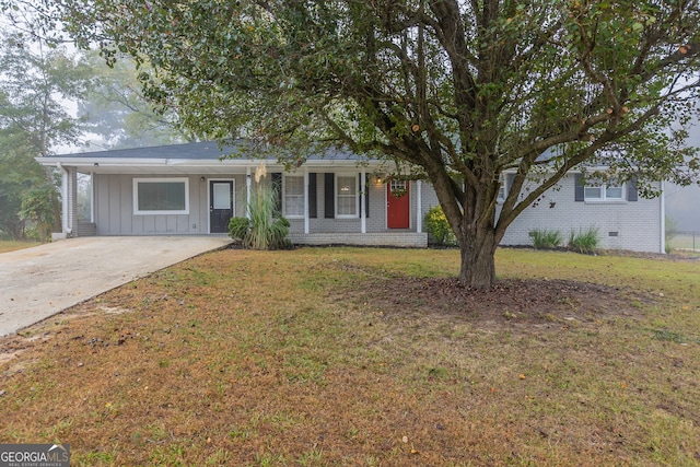 view of front of property with a carport and a front lawn