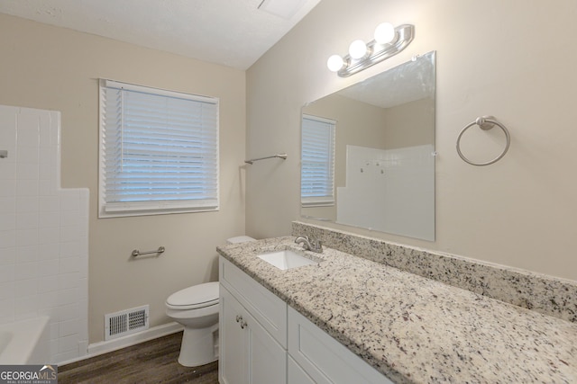 full bathroom featuring tub / shower combination, wood-type flooring, vanity, and toilet