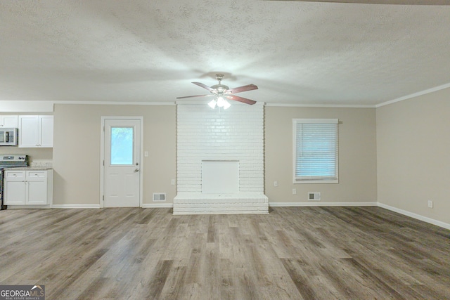 unfurnished living room with light hardwood / wood-style floors, a textured ceiling, and crown molding