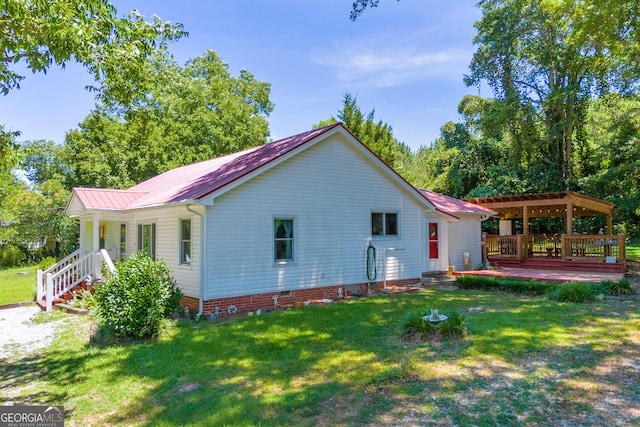 exterior space featuring a wooden deck and a yard