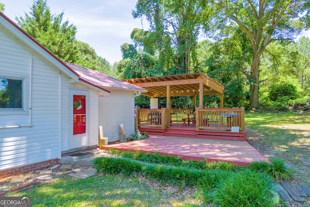 wooden terrace featuring a pergola and a lawn