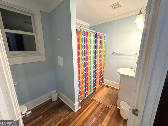 bathroom with vanity, hardwood / wood-style flooring, ornamental molding, and a shower with shower curtain