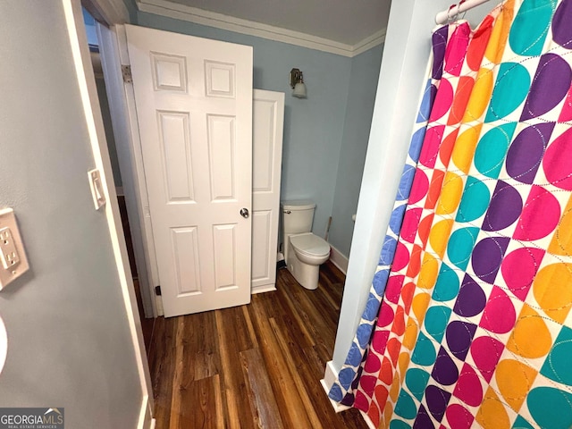 bathroom featuring crown molding, wood-type flooring, and toilet