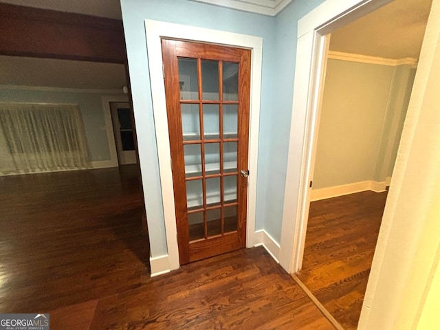 hallway with crown molding and dark hardwood / wood-style floors