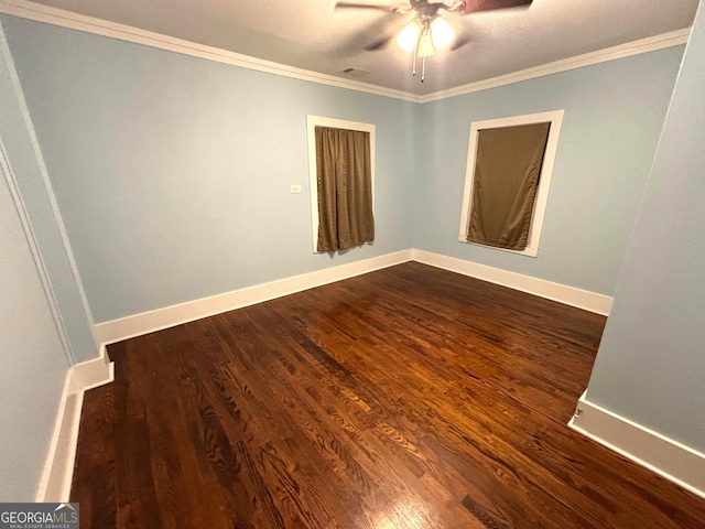 unfurnished room featuring dark wood-type flooring, ceiling fan, and crown molding