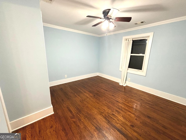 spare room featuring crown molding, dark wood-type flooring, and ceiling fan