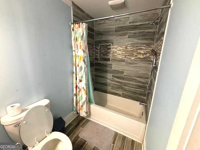 bathroom featuring shower / tub combo and toilet