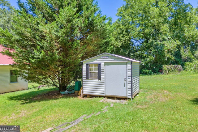 view of outbuilding with a yard