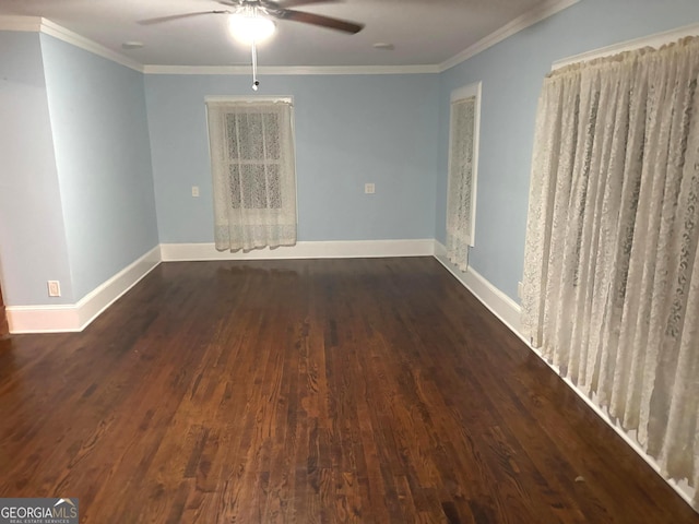 spare room with dark wood-type flooring, ornamental molding, and ceiling fan