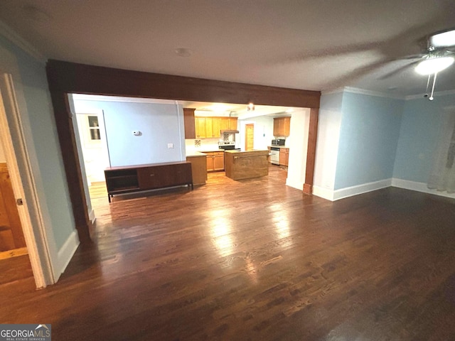 unfurnished living room featuring ornamental molding and dark wood-type flooring