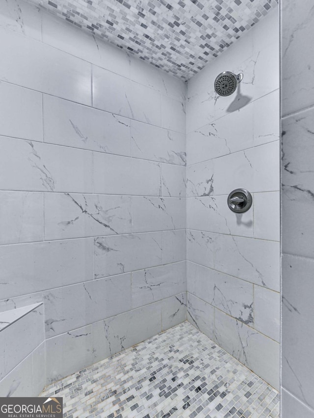 bathroom with a tile shower