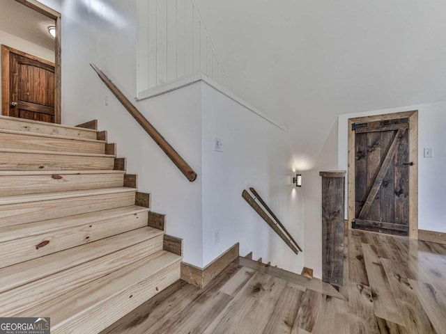 staircase featuring wood-type flooring