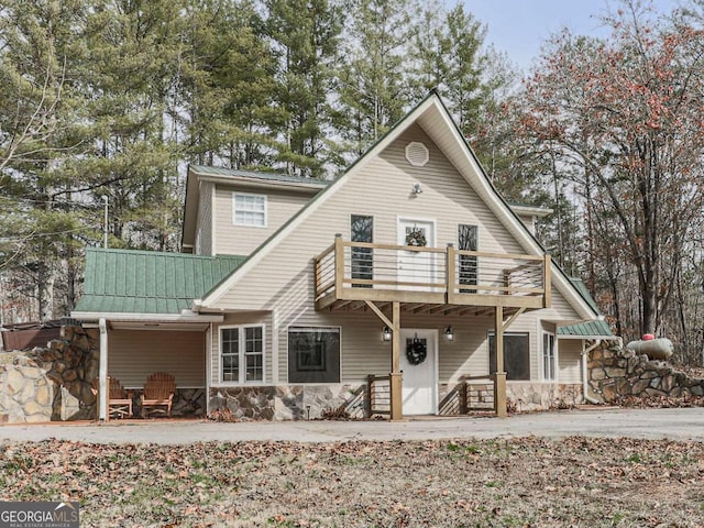 rear view of property featuring a balcony