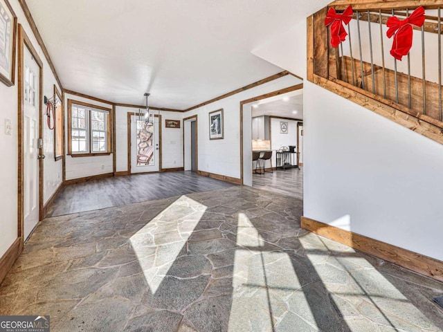 foyer featuring dark wood-type flooring and crown molding