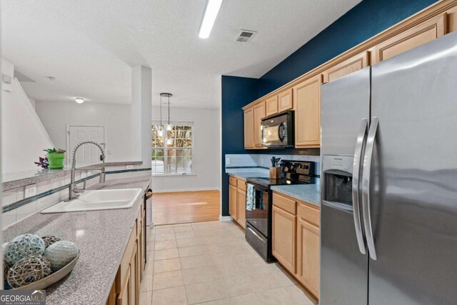 2357 Bayrose Cir Unit 57B, Atlanta, GA 30344 - kitchen featuring black appliances, light brown cabinetry, pendant lighting, and sink