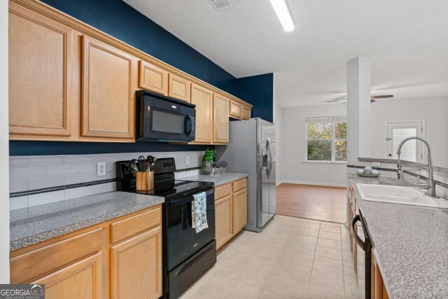 2357 Bayrose Cir Unit 57B, Atlanta, GA 30344 - kitchen featuring light brown cabinets, sink, black appliances, and light hardwood / wood-style flooring