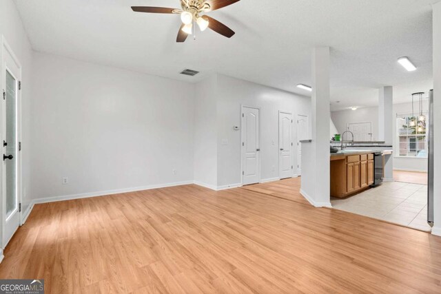 2357 Bayrose Cir Unit 57B, Atlanta, GA 30344 - unfurnished living room featuring light wood-type flooring and ceiling fan