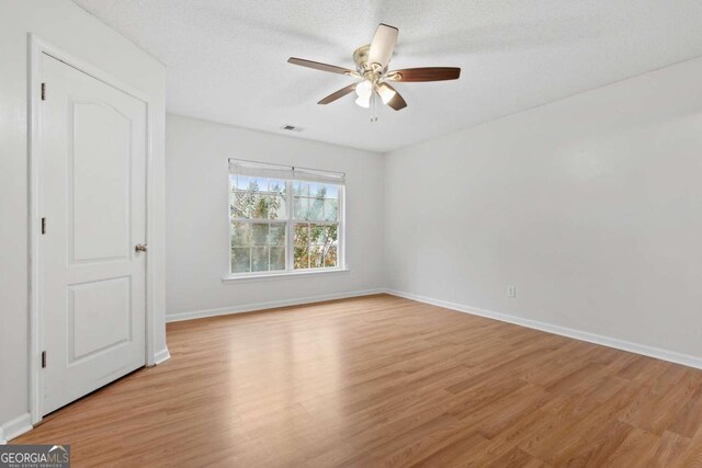 2357 Bayrose Cir Unit 57B, Atlanta, GA 30344 - unfurnished bedroom with light hardwood / wood-style floors, a textured ceiling, and ceiling fan