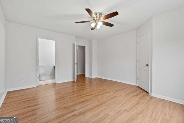 2357 Bayrose Cir Unit 57B, Atlanta, GA 30344 - unfurnished bedroom with light wood-type flooring, ceiling fan, and connected bathroom