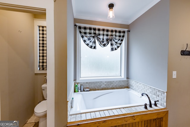 bathroom featuring ornamental molding, a bath, and toilet