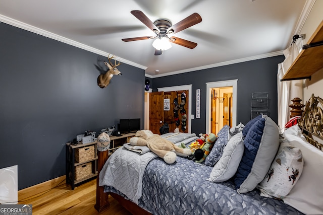 bedroom with ornamental molding, ceiling fan, and light hardwood / wood-style flooring