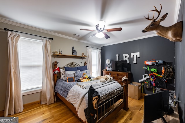 bedroom featuring hardwood / wood-style floors, ceiling fan, and ornamental molding