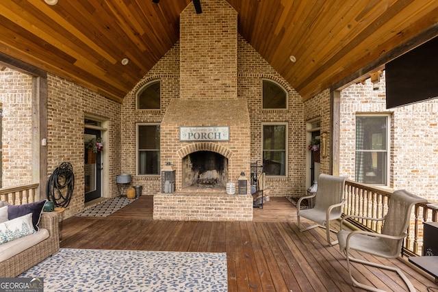 wooden deck featuring an outdoor brick fireplace