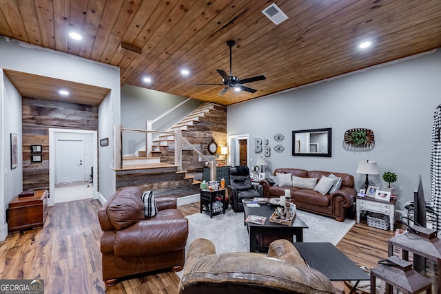 living room featuring hardwood / wood-style floors, wooden ceiling, and ceiling fan