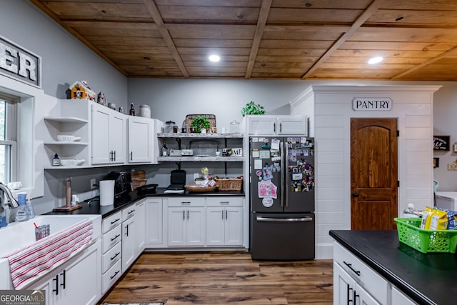 kitchen featuring fridge, white cabinetry, wood ceiling, and dark hardwood / wood-style floors