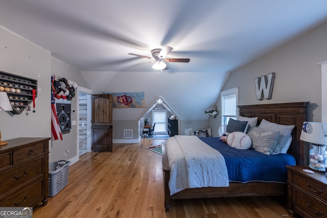 bedroom with vaulted ceiling, ceiling fan, and light hardwood / wood-style flooring