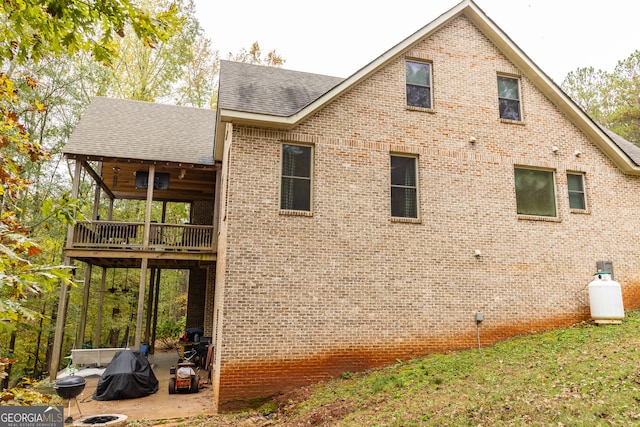 back of house featuring a balcony